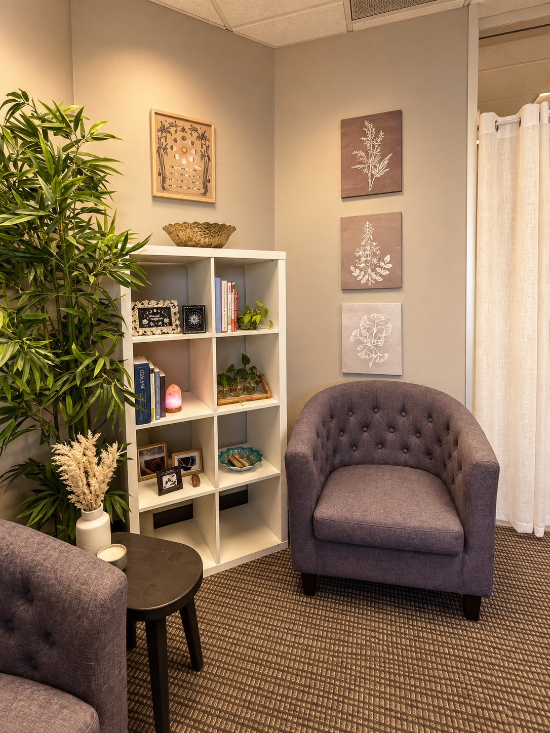 Women’s Recovery Denver office Two upholstered chairs and a bookshelf in a Women’s Recovery office