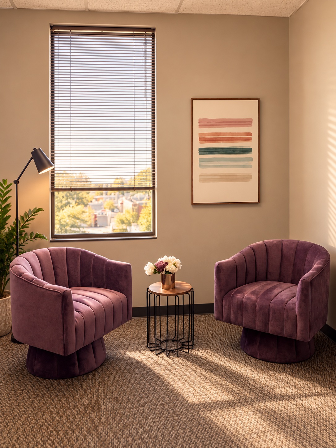 Women’s Recovery Denver office Plum armchairs beside a window table