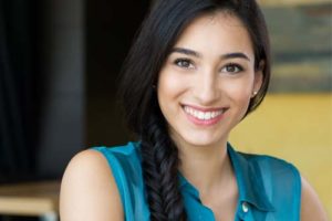 smiling young woman receiving answers to frequently asked questions about Women's Recovery in Colorado.